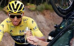 Bernal toasts with champagne at the car of his team director Credit: AP